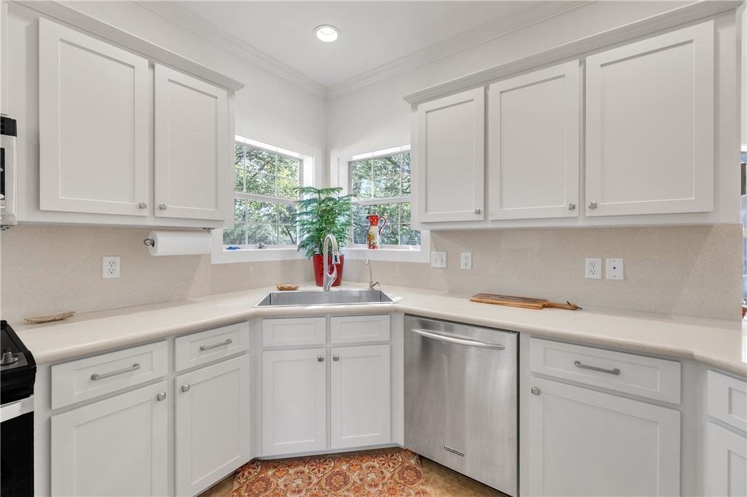 9618 Whispering Ridge College Station, TX 77845 - Photo 10 of 27 a kitchen with white cabinets and a window