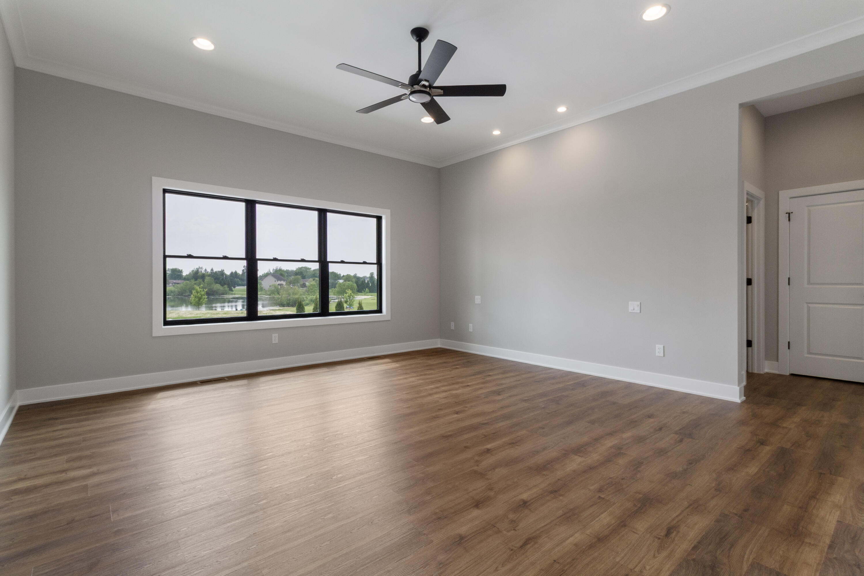 3659 Towle Street Dyer, IN 46311 - Photo 18 of 28 an empty room with wooden floor and windows