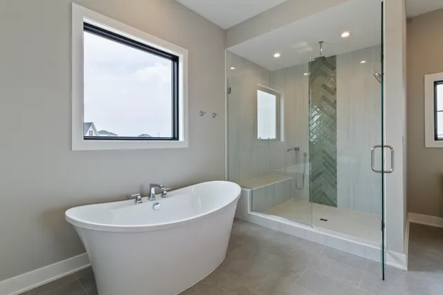 a white bath tub sitting next to a bathroom sink