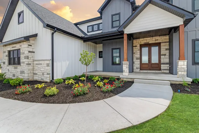 a view of a house with potted plants
