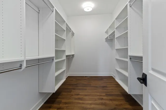 a view of walk in closet with empty racks