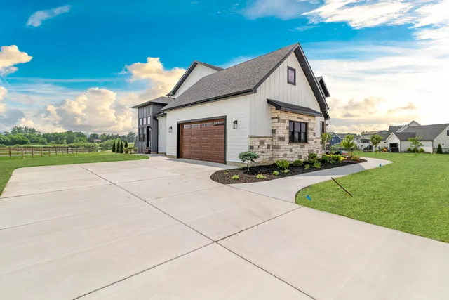 a front view of house with yard and green space