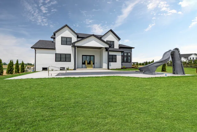 a front view of house with yard and green space