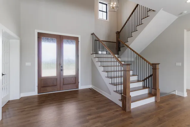 a view of entryway with wooden floor and stairs