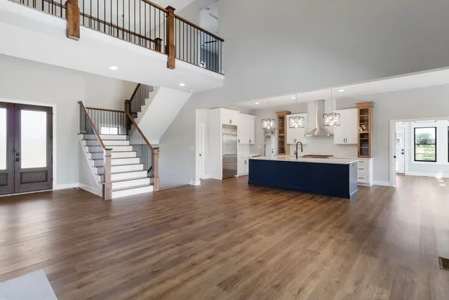 a view of a kitchen with furniture and wooden floor