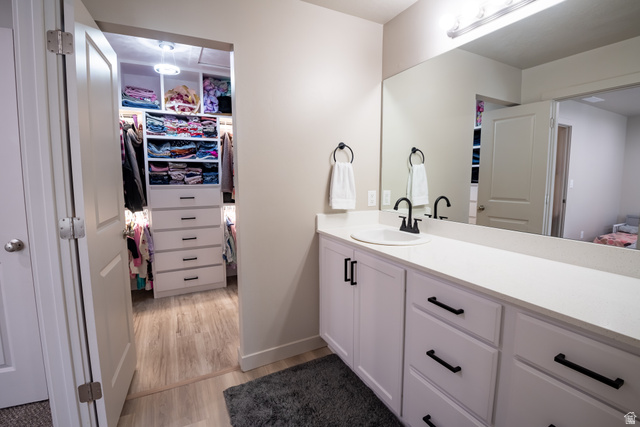 1787 North 1280 East Payson, UT 84651 - Photo 15 of 22 Vanity with a white countertop and integrated sink, matte black faucet, and white cabinetry with black hardware