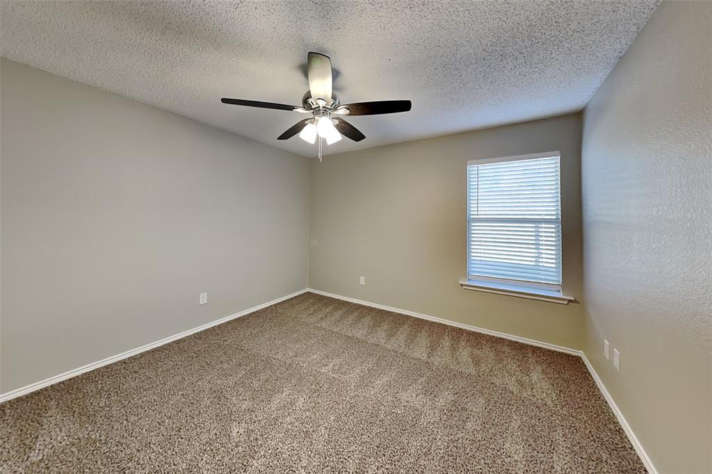 1200 Rambling Brook Trail Denton, TX 76210 - Photo 14 of 21 an empty room with a window and a fan