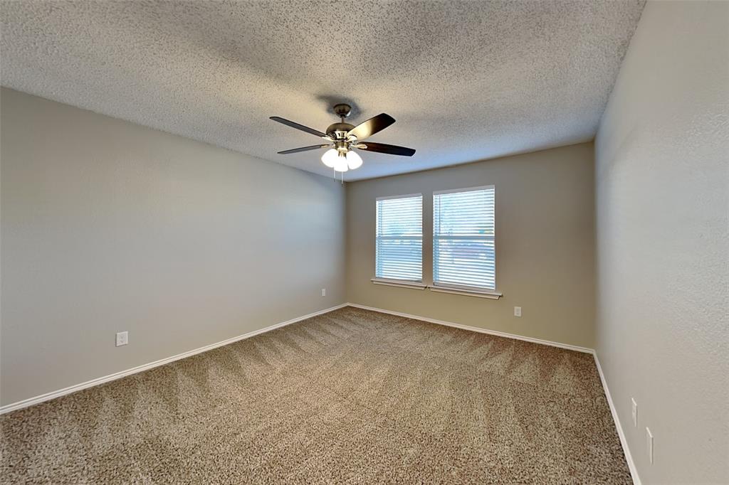 1200 Rambling Brook Trail Denton, TX 76210 - Photo 16 of 21 an empty room with windows and ceiling fan