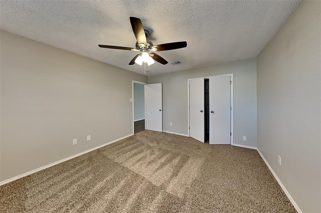 1200 Rambling Brook Trail Denton, TX 76210 - Photo 17 of 21 a view of a big room with carpet and chandelier fan