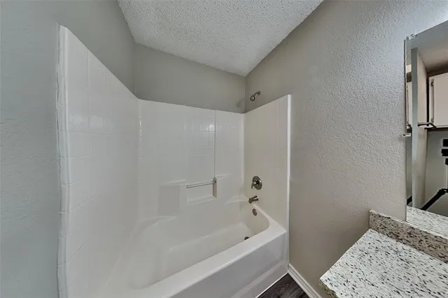 a bathroom with a bathtub and a sink