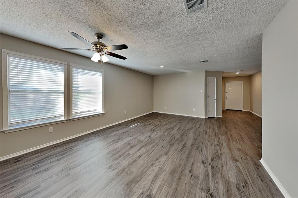 1200 Rambling Brook Trail Denton, TX 76210 - Photo 4 of 21 wooden floor in an empty room with a window