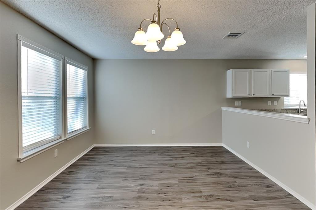 1200 Rambling Brook Trail Denton, TX 76210 - Photo 6 of 21 a view of a kitchen with a dishwasher cabinets and wooden floor