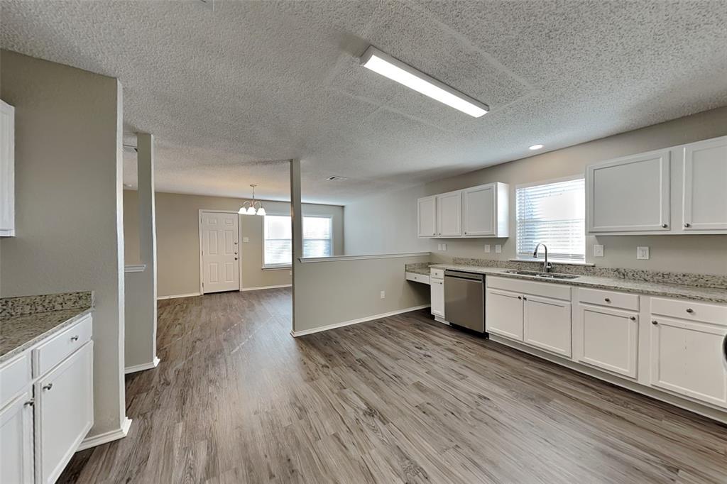 1200 Rambling Brook Trail Denton, TX 76210 - Photo 7 of 21 a large kitchen with a wooden floor and stainless steel appliances