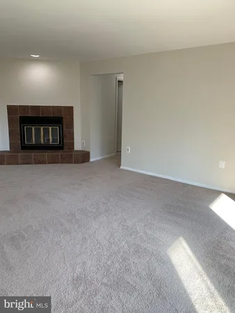 a view of an empty room with a fireplace