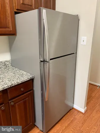 a white refrigerator freezer sitting in a kitchen