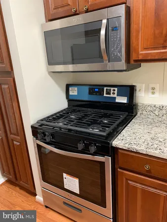 a stove top oven sitting inside of a kitchen