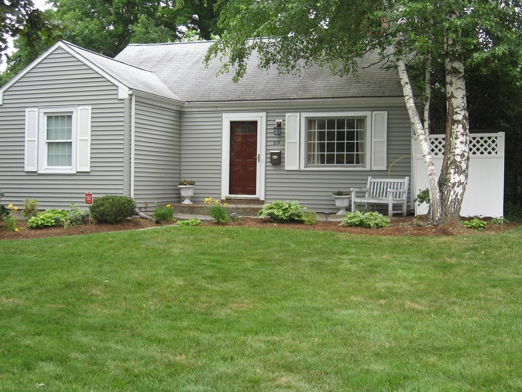 59 Mayflower Road Springfield, MA 01118 - Photo 1 of 27 a front view of a house with a yard and outdoor seating