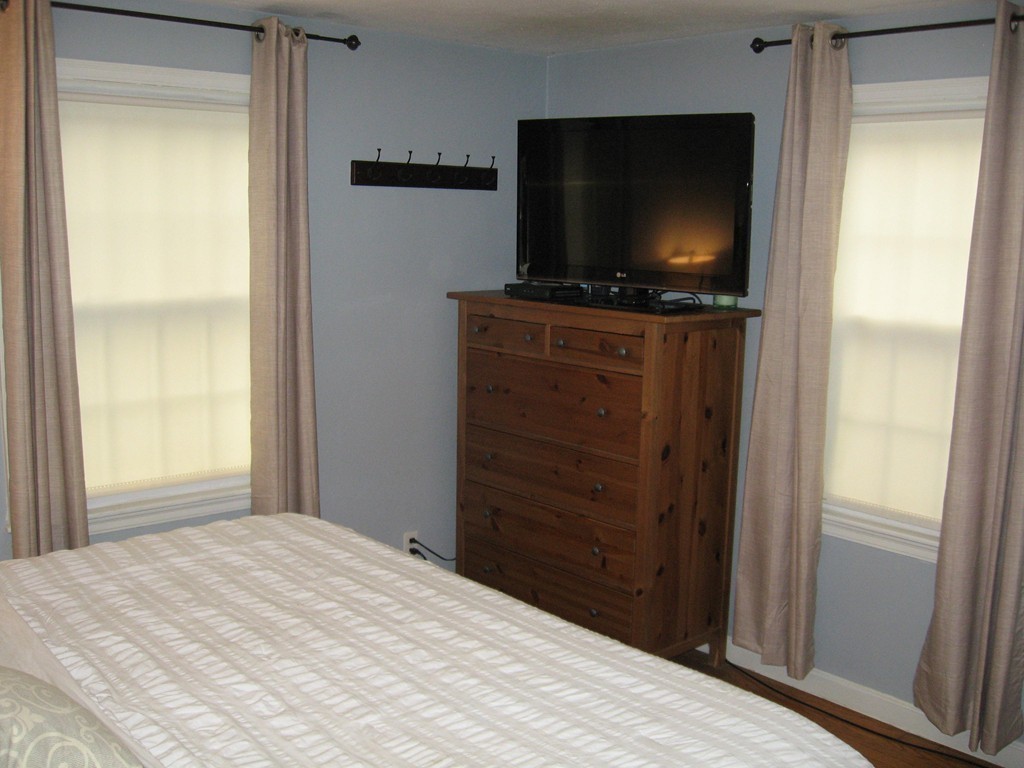 59 Mayflower Road Springfield, MA 01118 - Photo 15 of 27 a bedroom with a flat screen tv and wooden floor