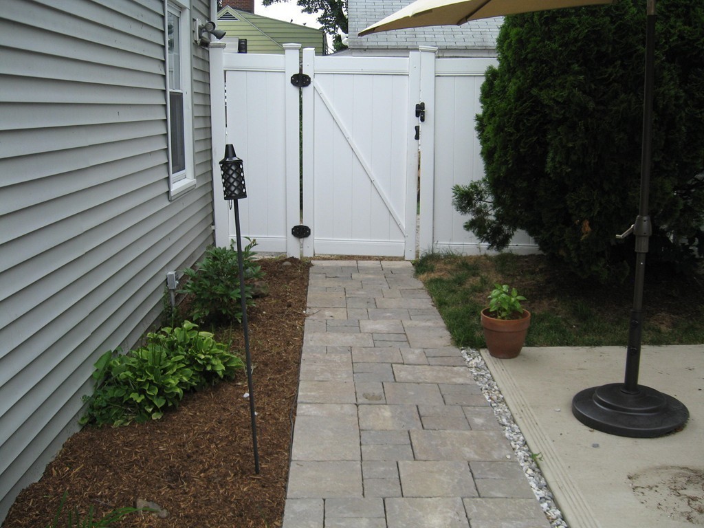 59 Mayflower Road Springfield, MA 01118 - Photo 21 of 27 a view of a backyard with plants and a potted plant