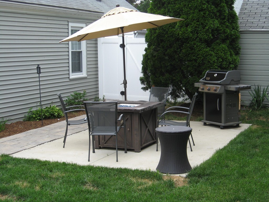 59 Mayflower Road Springfield, MA 01118 - Photo 24 of 27 a view of a patio with table and chairs potted plants and a palm tree
