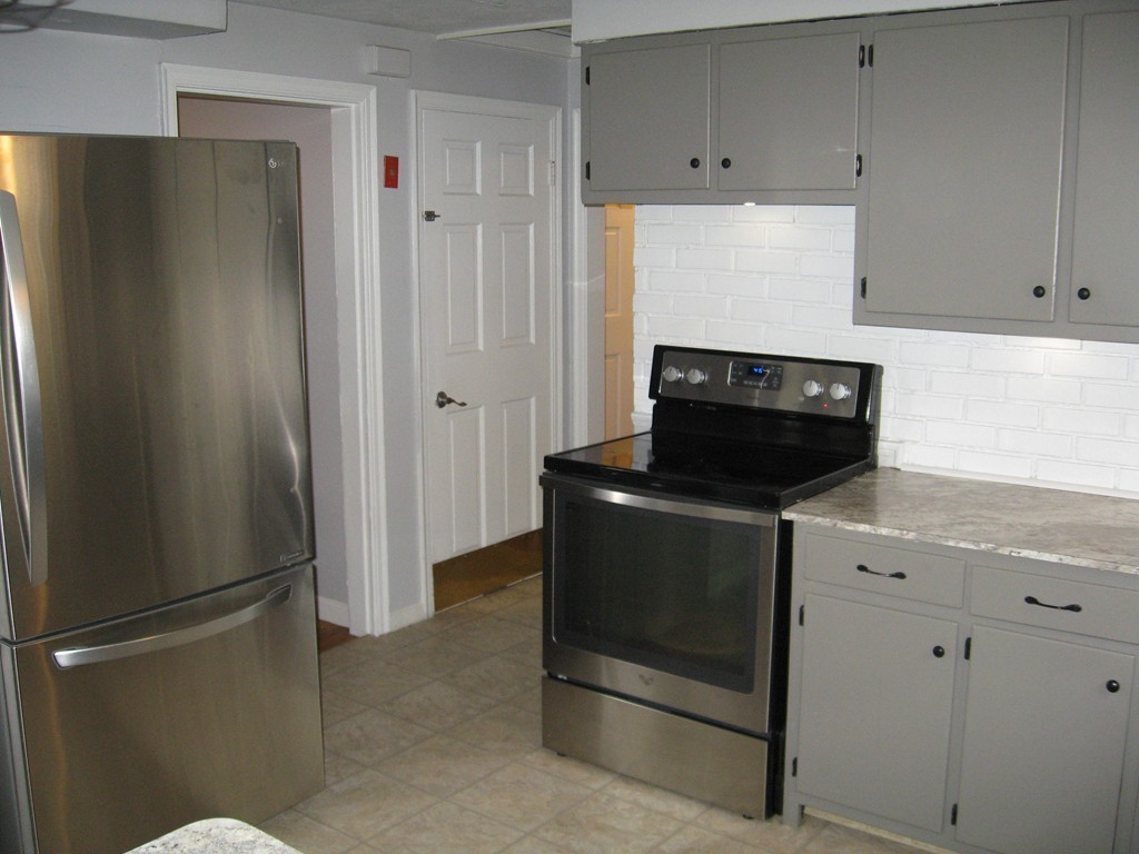59 Mayflower Road Springfield, MA 01118 - Photo 9 of 27 a kitchen with stainless steel appliances a refrigerator and cabinets