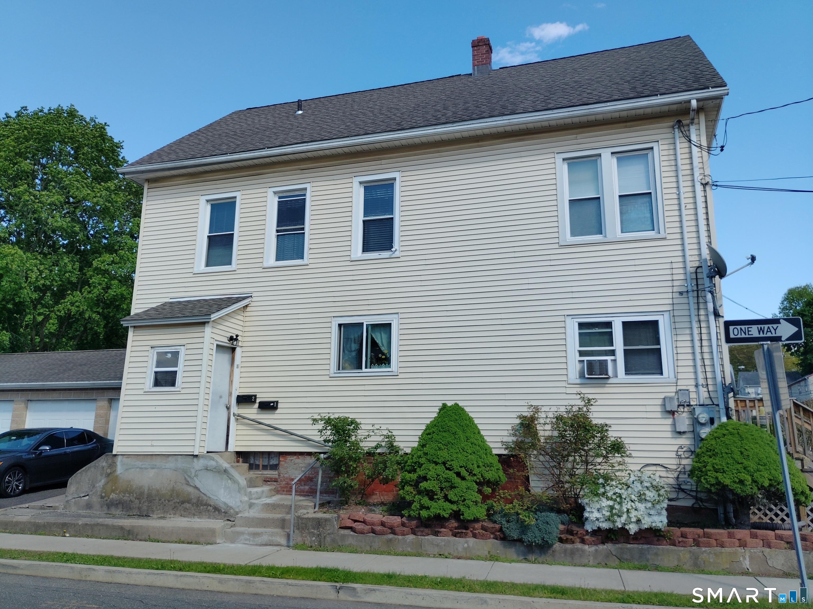 61 Bartlett Street Meriden, CT 06451 - Photo 2 of 30 a front view of a house with plants
