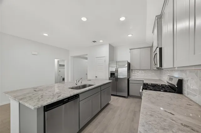a kitchen with a sink and refrigerator