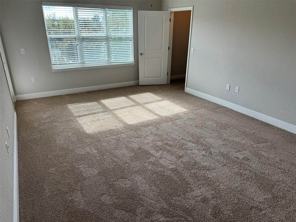 2420 Ann Rou Road, Unit 201 Tavares, FL 32778 - Photo 8 of 25 an empty room with windows