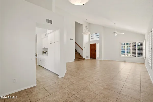 an empty room with windows and entrance