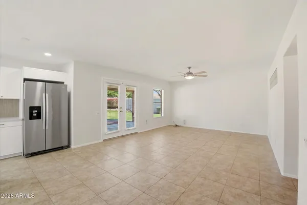 an empty room with windows and cabinet