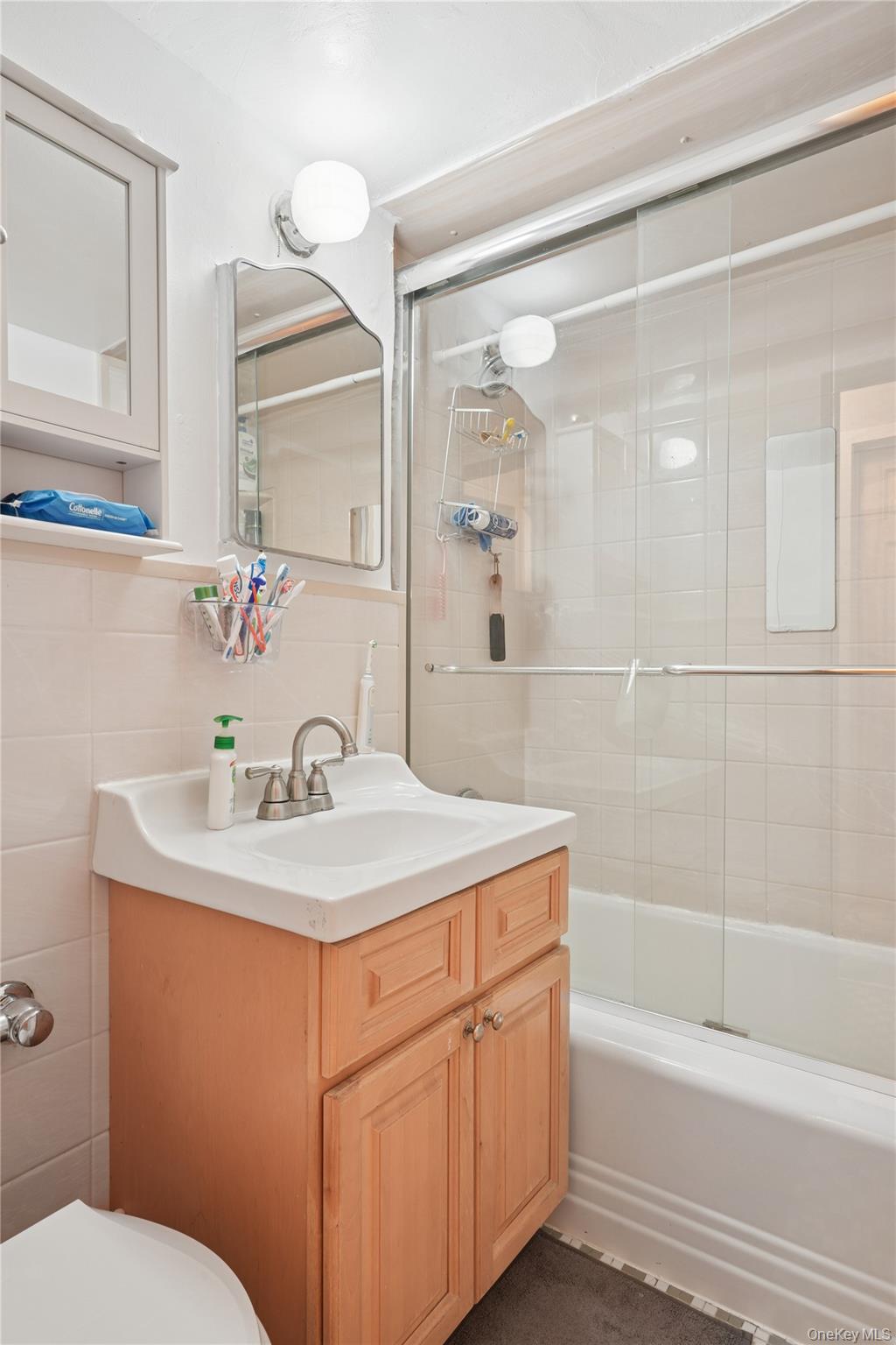 35-50 85th Street, Unit 3D Queens, NY 11372 - Photo 13 of 15 a bathroom with a sink toilet vanity and shower