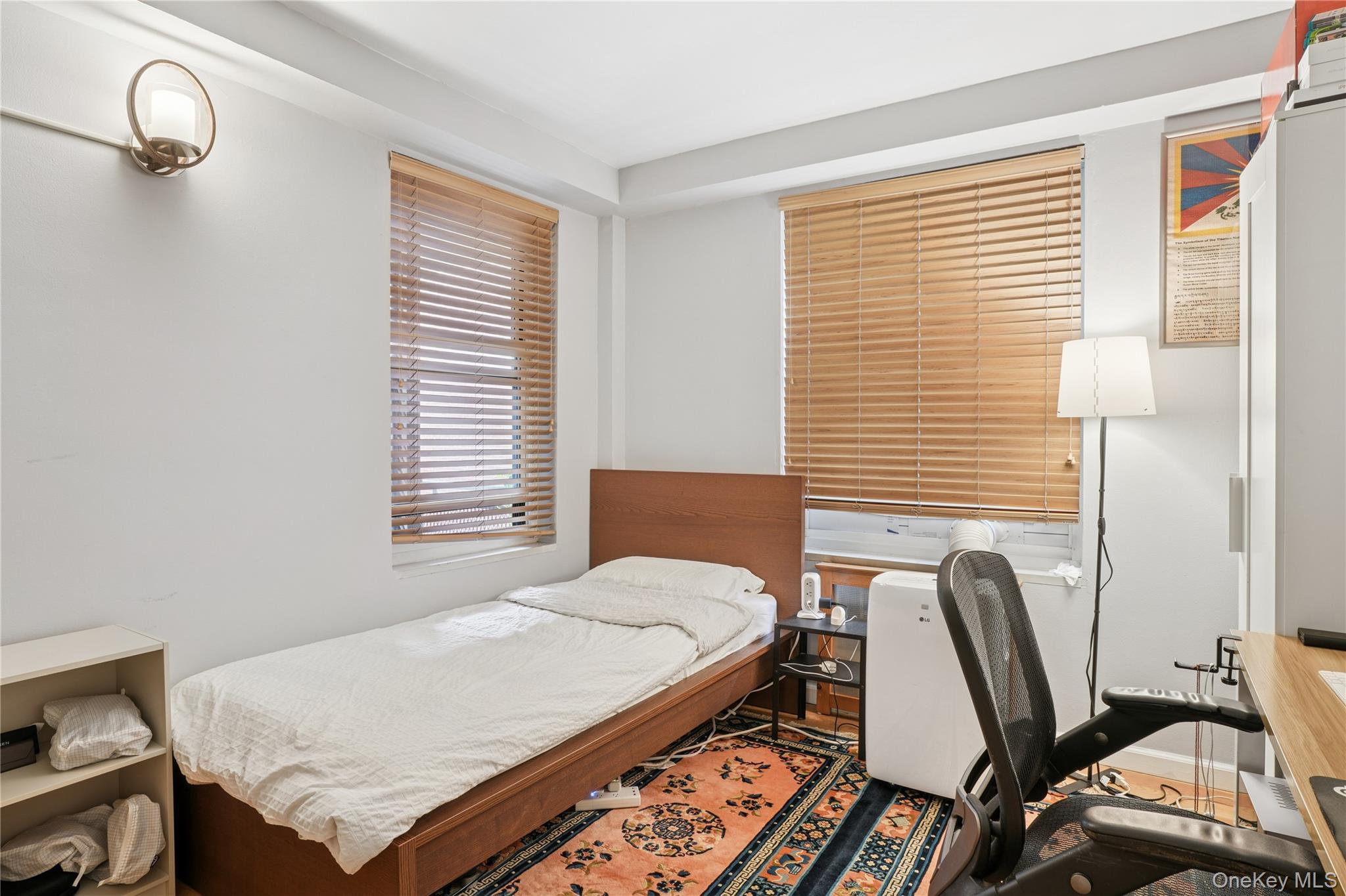 35-50 85th Street, Unit 3D Queens, NY 11372 - Photo 14 of 15 a bedroom with a bed a chair and a large window