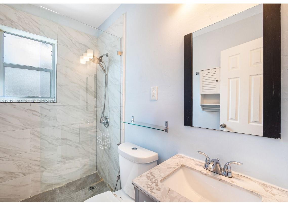 2255 Southwest 10th Street, Unit B Miami, FL 33135 - Photo 19 of 26 a bathroom with a granite countertop sink toilet and shower