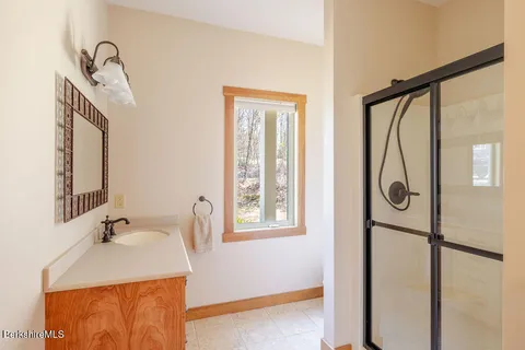 a bathroom with a sink vanity and a mirror