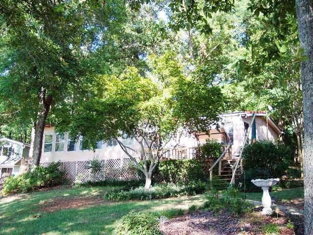 252 Tussahaw Inn Road Jackson, GA 30233 - Photo 1 of 1 a view of a backyard with table and chairs and a large tree