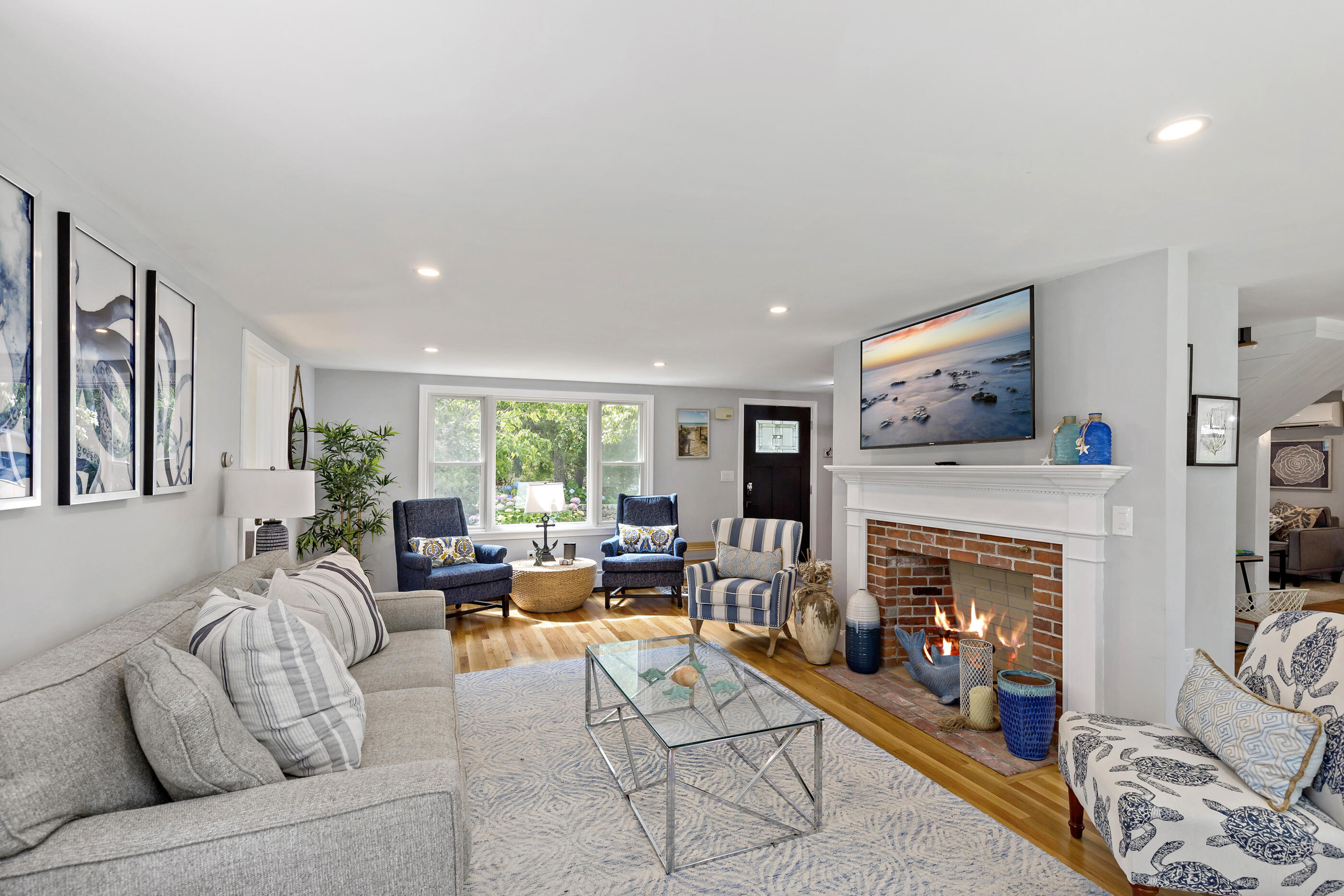 414 Eel River Road Osterville, MA 02655 - Photo 16 of 40 a living room with furniture large window and a fireplace