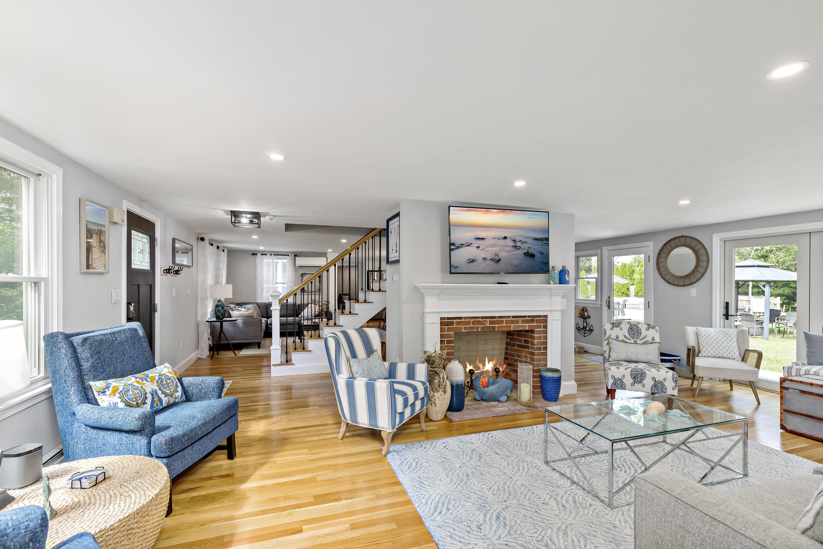 414 Eel River Road Osterville, MA 02655 - Photo 17 of 40 a living room with furniture and a fireplace