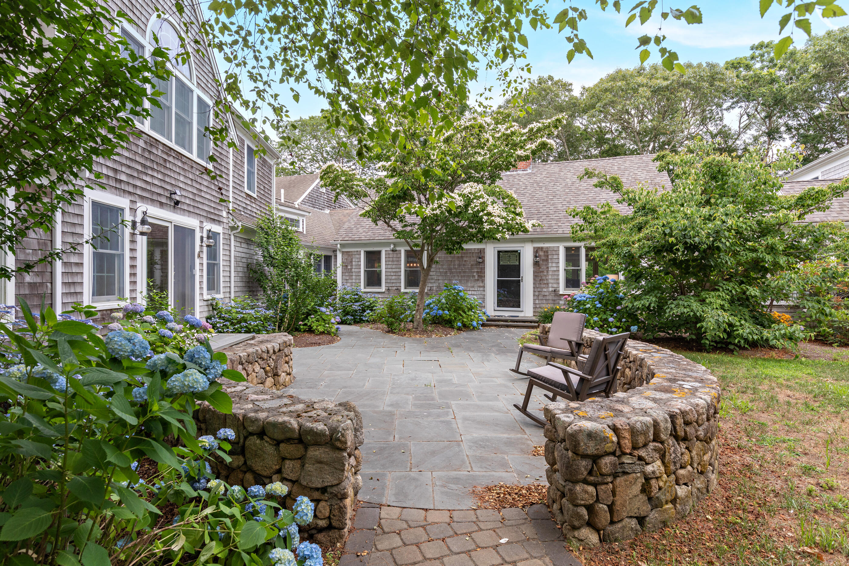 414 Eel River Road Osterville, MA 02655 - Photo 2 of 40 a view of a house with backyard sitting area and garden