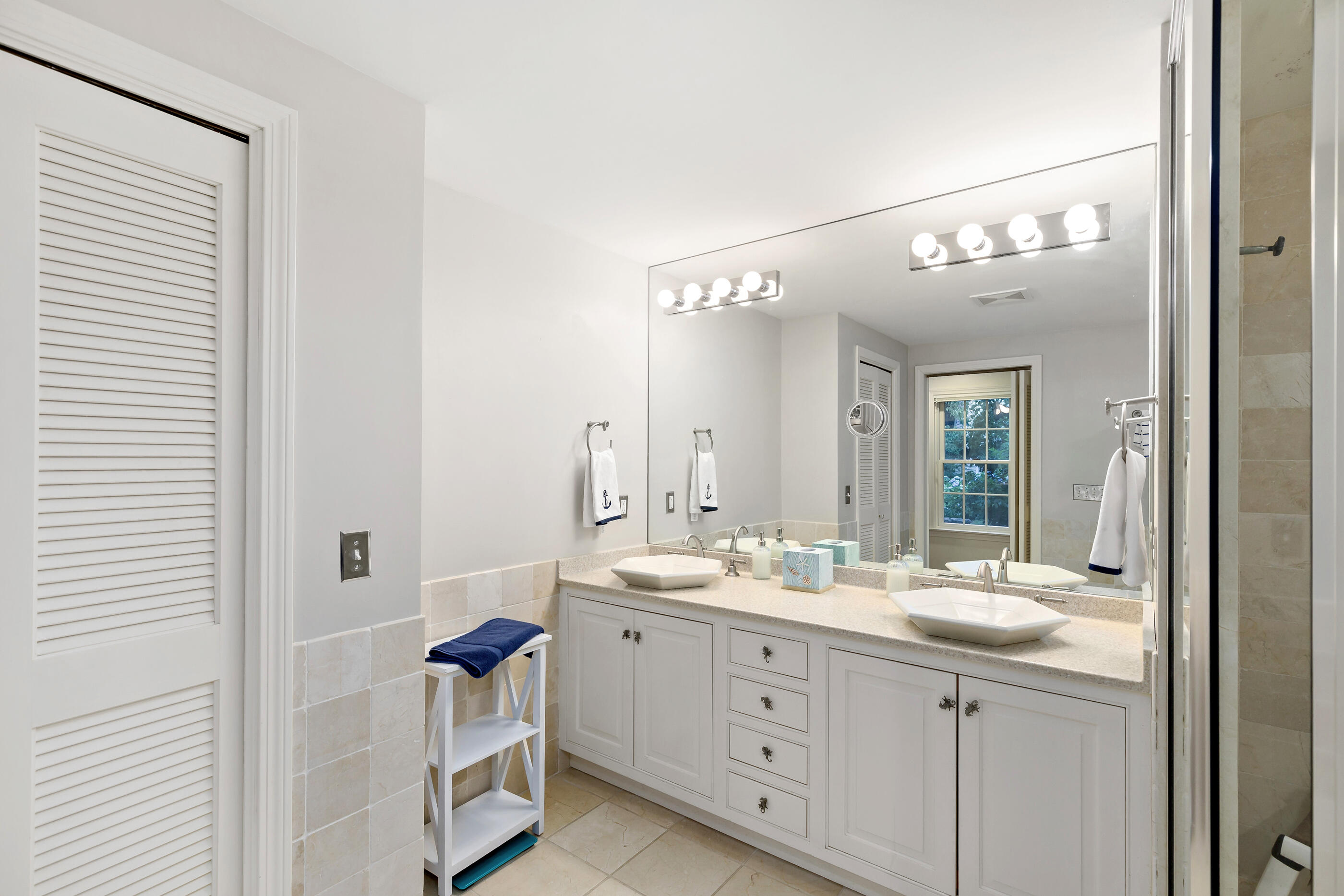 414 Eel River Road Osterville, MA 02655 - Photo 24 of 40 a bathroom with a double vanity sink a mirror and a shower