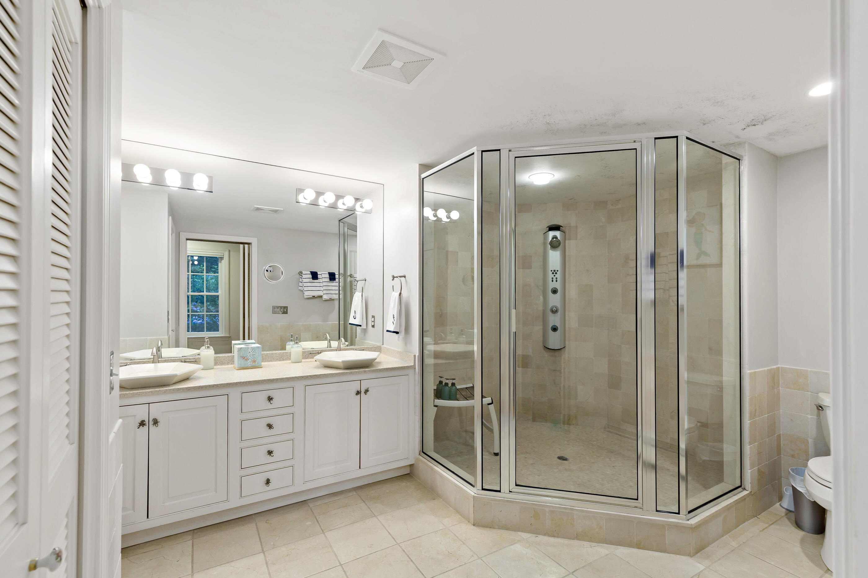 414 Eel River Road Osterville, MA 02655 - Photo 25 of 40 a bathroom with a shower sink mirror and toilet