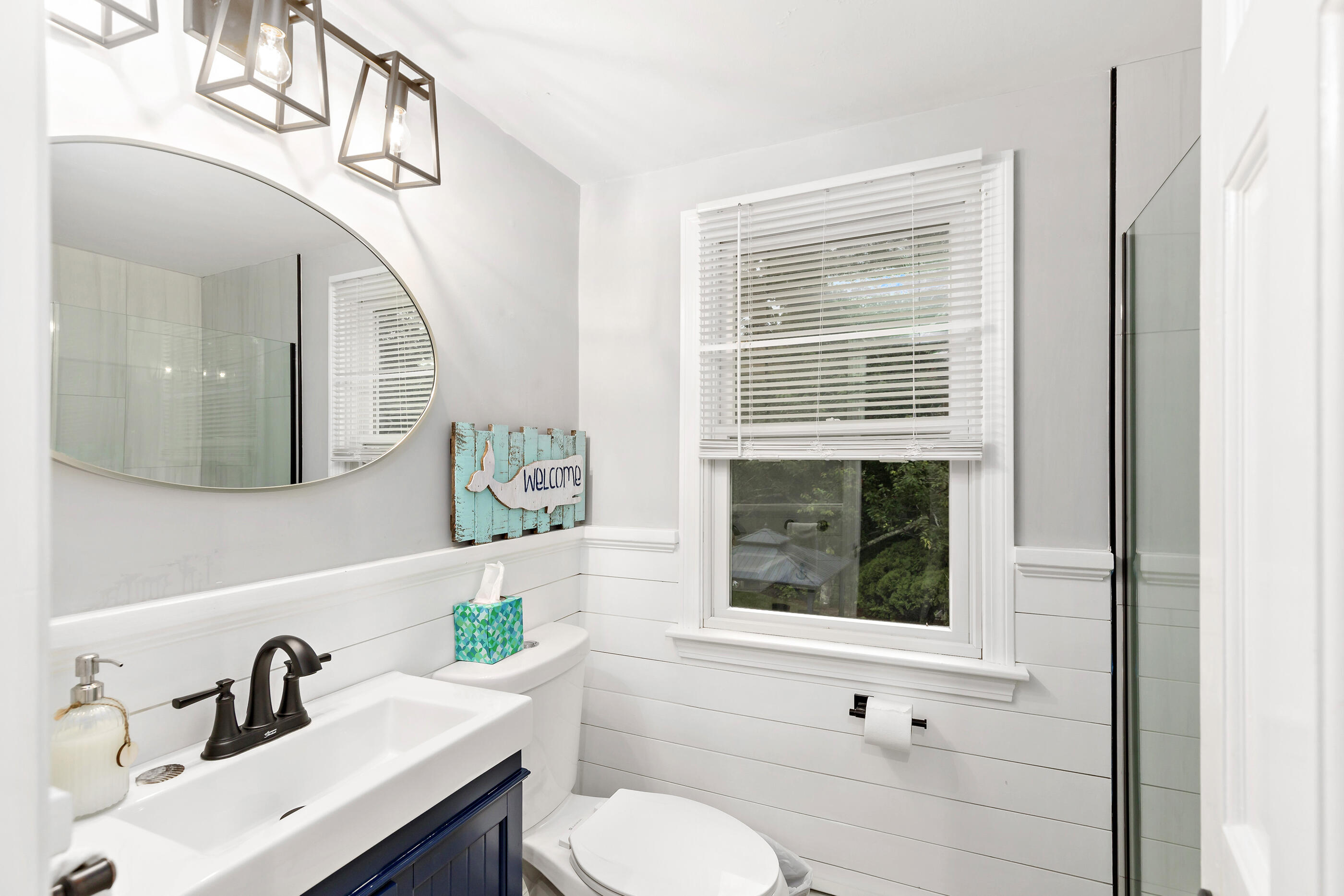 414 Eel River Road Osterville, MA 02655 - Photo 35 of 40 a bathroom with a sink a mirror a toilet and a window