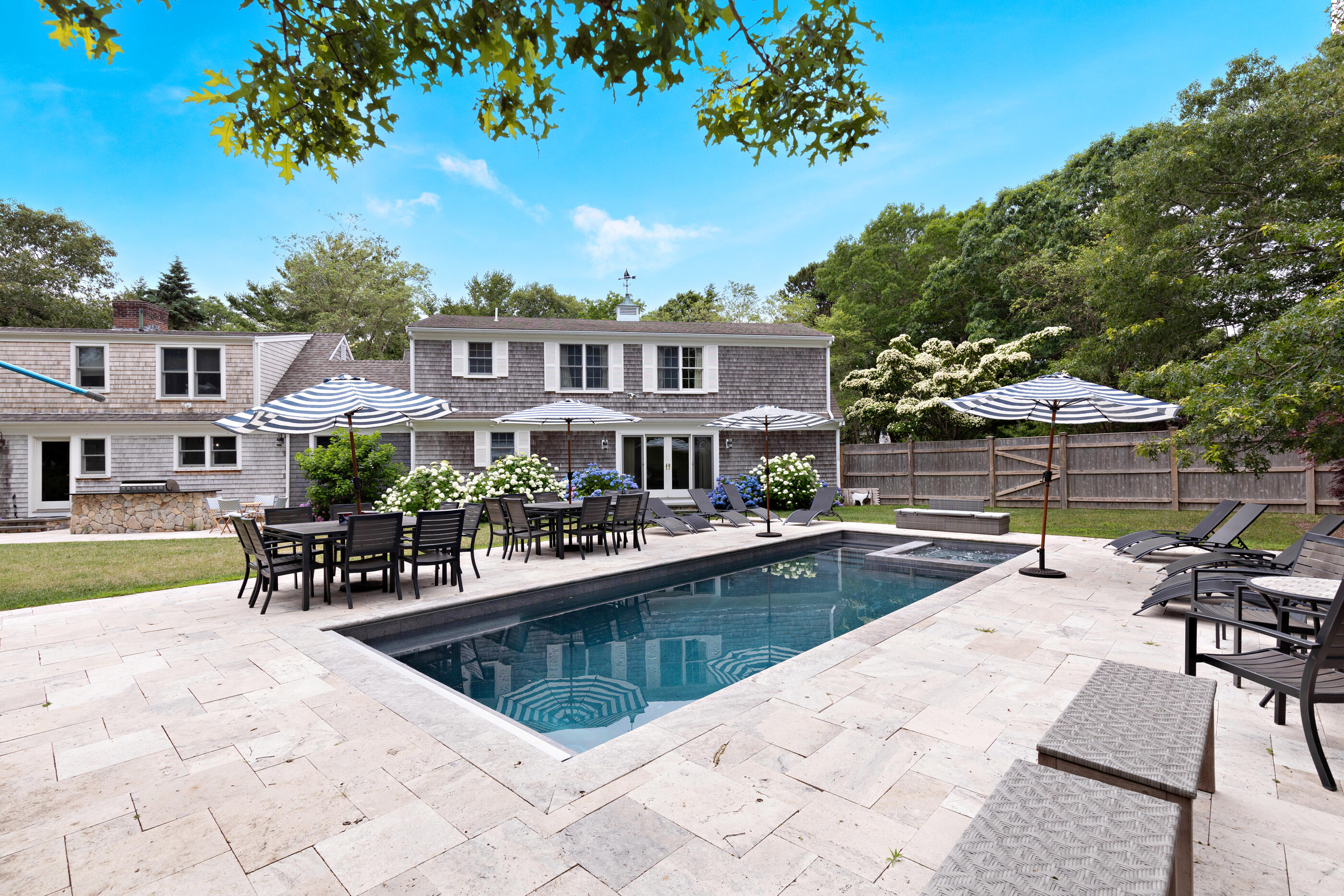 414 Eel River Road Osterville, MA 02655 - Photo 5 of 40 a view of a building with a swimming pool and sitting area