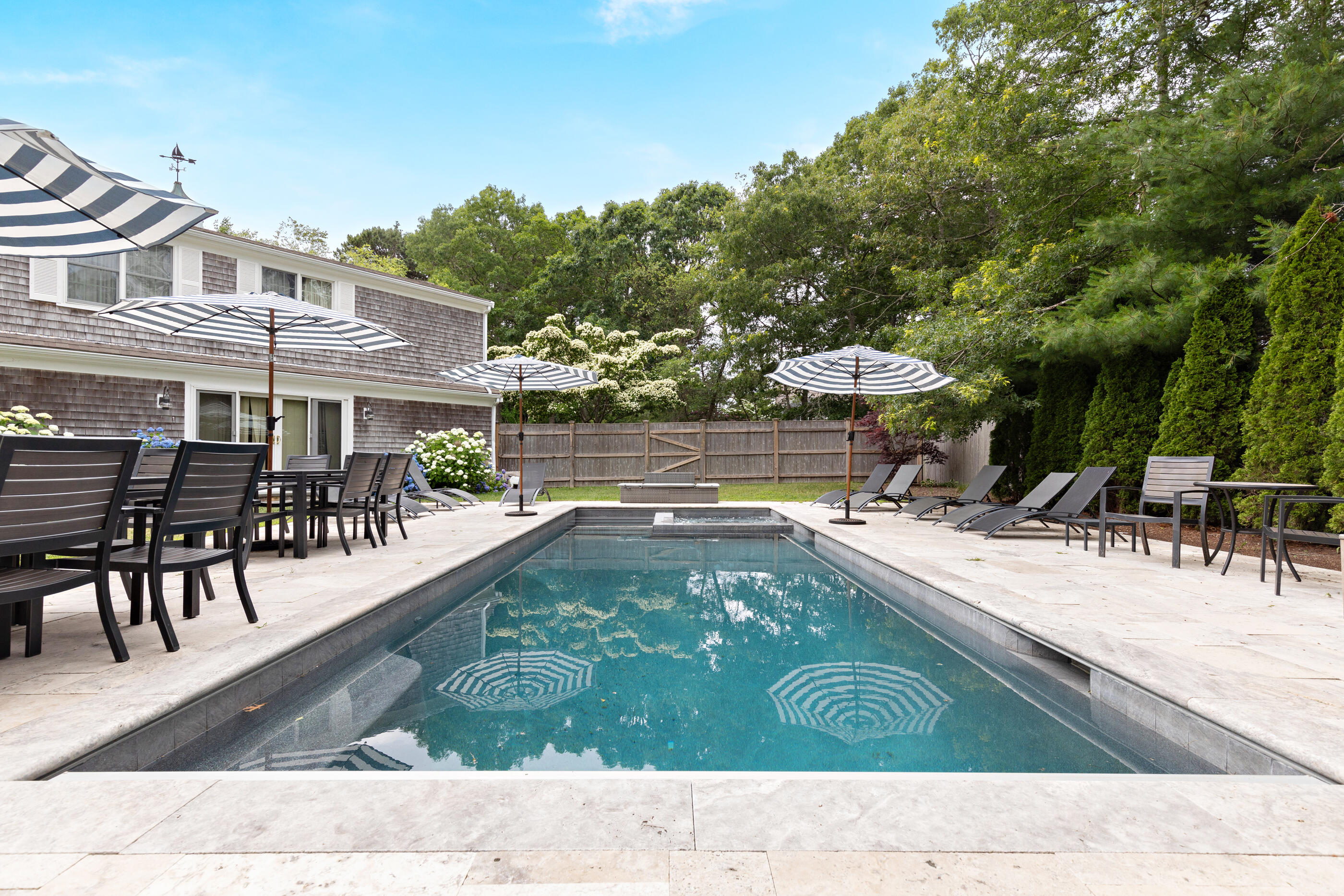 414 Eel River Road Osterville, MA 02655 - Photo 6 of 40 a view of a swimming pool with a lounge chair
