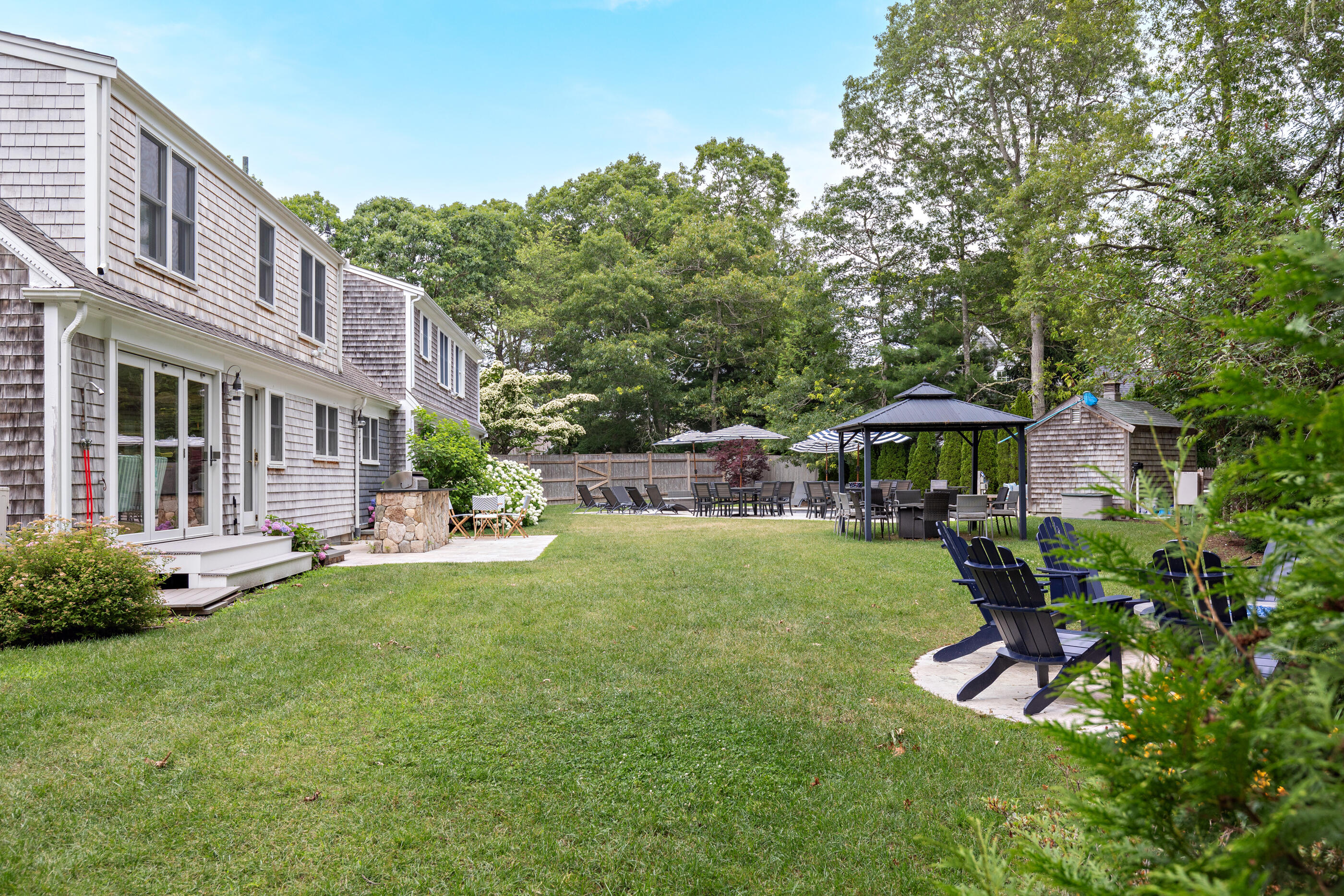 414 Eel River Road Osterville, MA 02655 - Photo 7 of 40 a view of a house with backyard sitting area and garden
