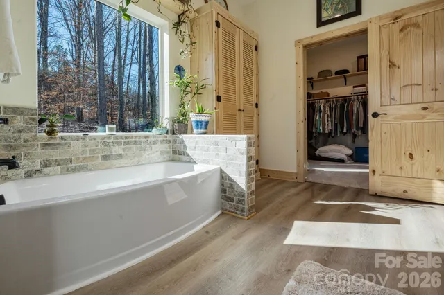 a backyard of a house with barbeque oven table and chairs