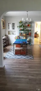 a living room with furniture and painting on the wall