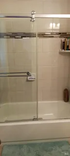 a bathroom with a shower and a bath tub