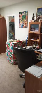 a room with a table chairs and appliances