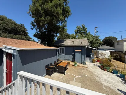 a view of a patio with table and chairs with wooden fence
