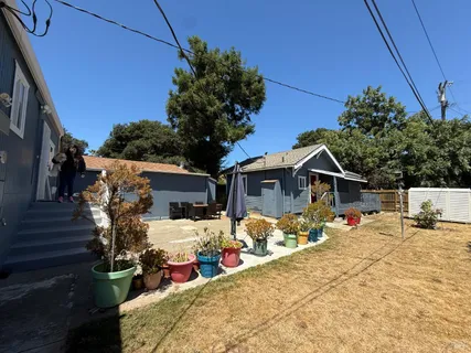 a view of a house with a yard covered in snow